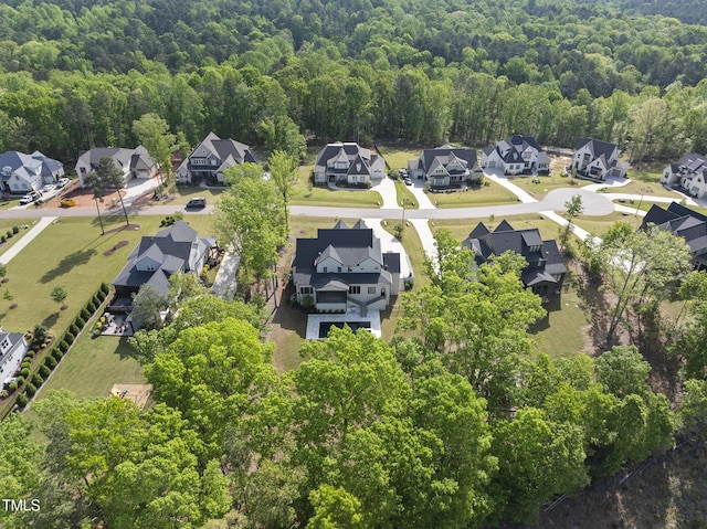 birds eye view of property with a forest view and a residential view