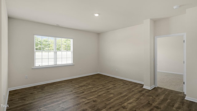 unfurnished room with dark hardwood / wood-style floors