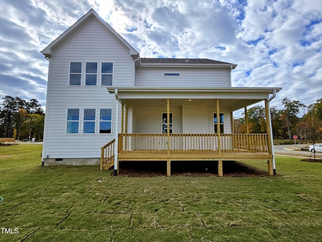 rear view of property with a yard