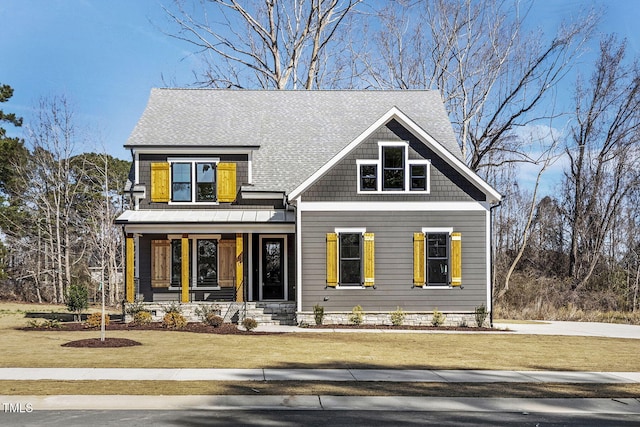 view of front of home with a front yard and roof with shingles