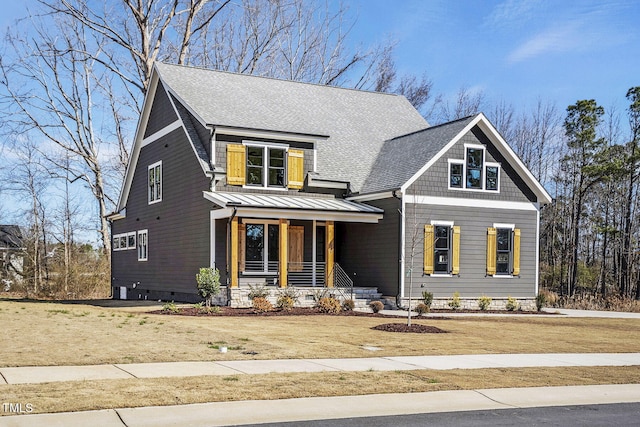 view of front of property featuring a shingled roof, covered porch, a standing seam roof, crawl space, and metal roof