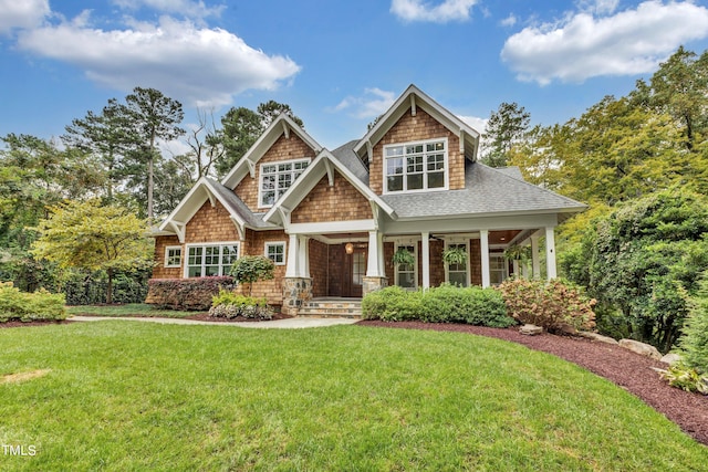 craftsman inspired home featuring a front lawn and a porch