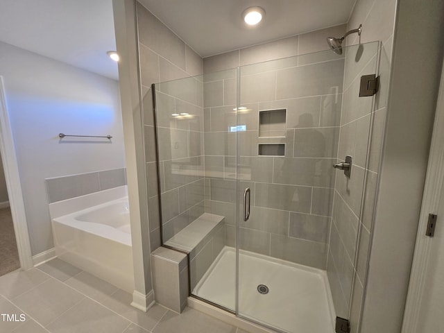 bathroom with tile patterned flooring and plus walk in shower