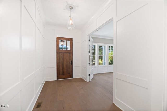 foyer with dark hardwood / wood-style floors and ornamental molding