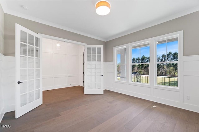 empty room with crown molding, french doors, and hardwood / wood-style floors