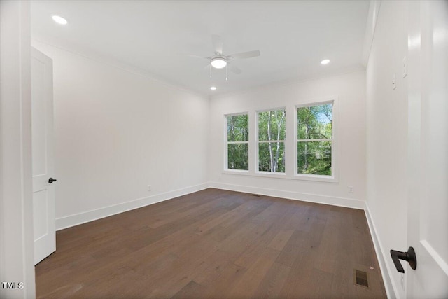 spare room featuring dark hardwood / wood-style floors, ceiling fan, and ornamental molding