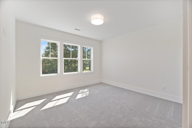 spare room with light colored carpet