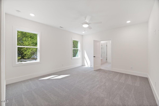 carpeted empty room with plenty of natural light and ceiling fan