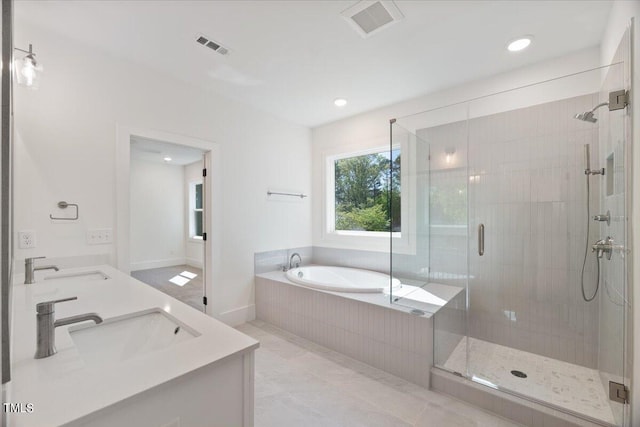 bathroom with tile patterned flooring, vanity, and shower with separate bathtub