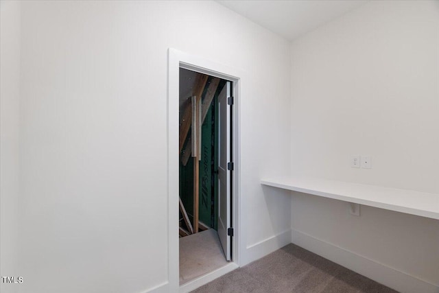 hallway with light colored carpet