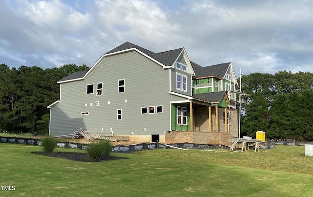 rear view of house featuring a yard