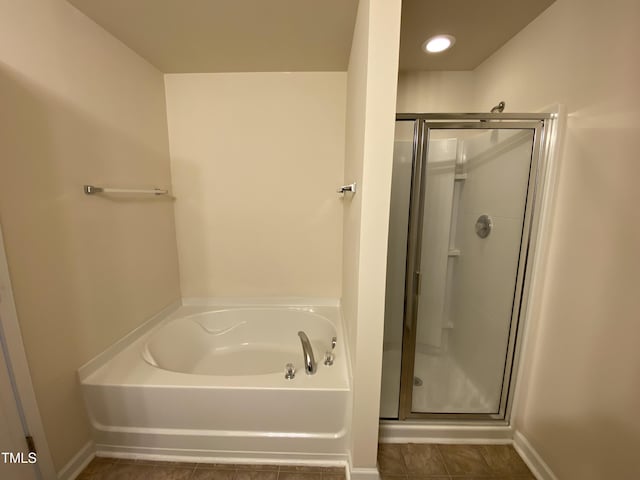 bathroom with tile patterned flooring and plus walk in shower