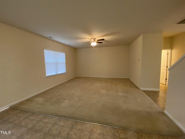 spare room featuring carpet flooring and ceiling fan