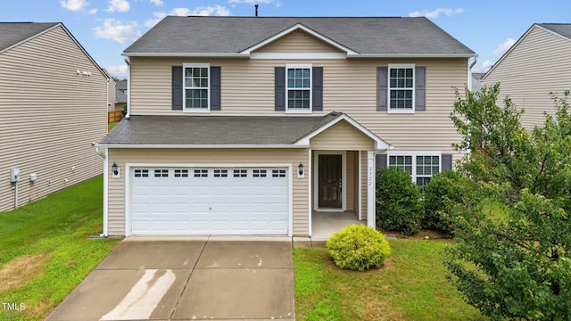 view of front of property featuring a garage and a front yard