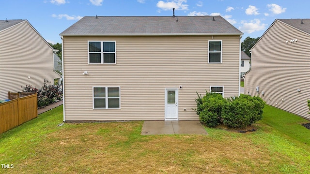 back of property with a lawn and a patio