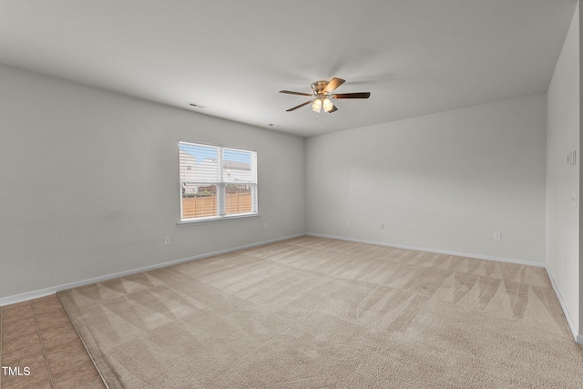 carpeted spare room with ceiling fan