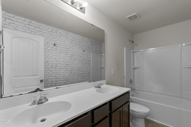 full bathroom featuring tile patterned floors, toilet, shower / bathtub combination, vanity, and brick wall