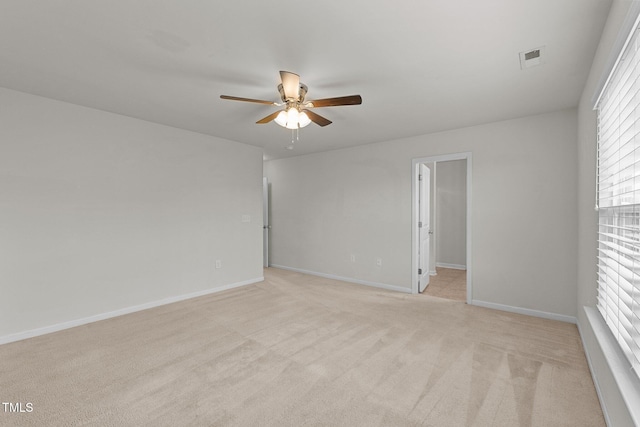 carpeted spare room with ceiling fan