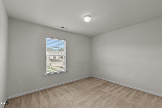 unfurnished room with light colored carpet