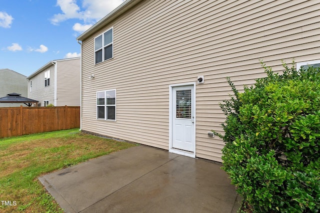 rear view of property with a yard and a patio area