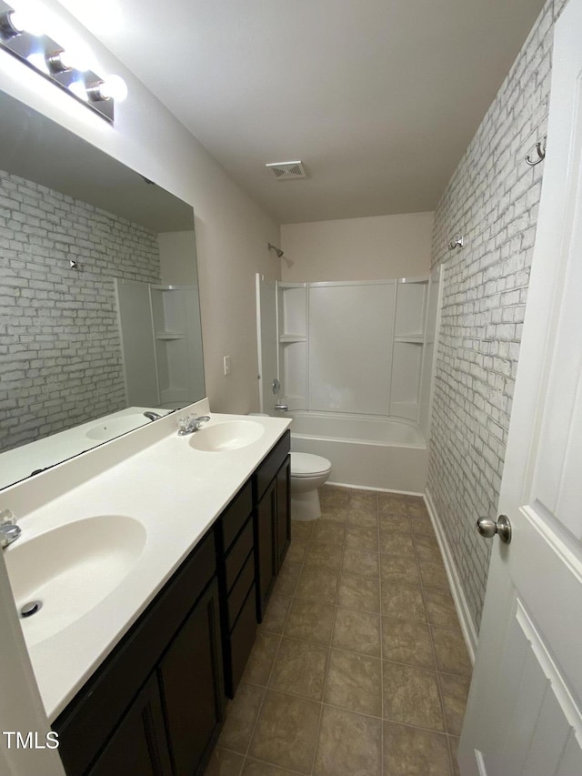 full bathroom featuring brick wall, shower / bath combination, vanity, toilet, and tile patterned floors