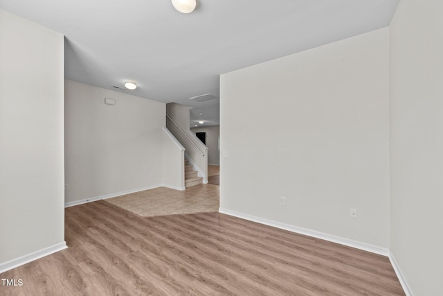 interior space with stairway, baseboards, and light wood-type flooring