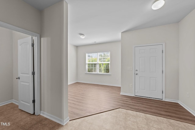 tiled foyer with baseboards
