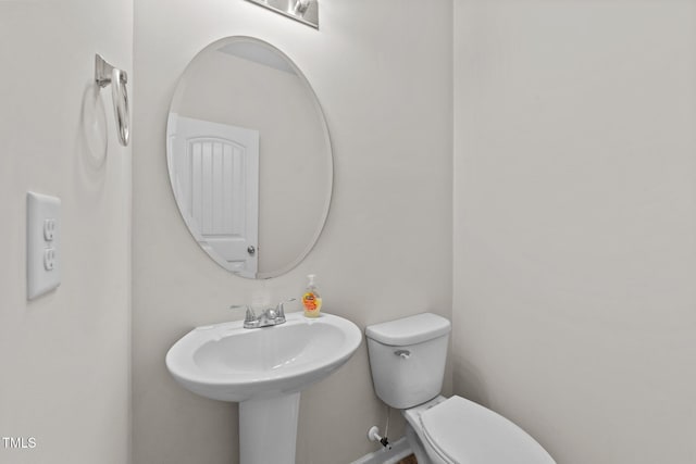 half bathroom with a sink and toilet
