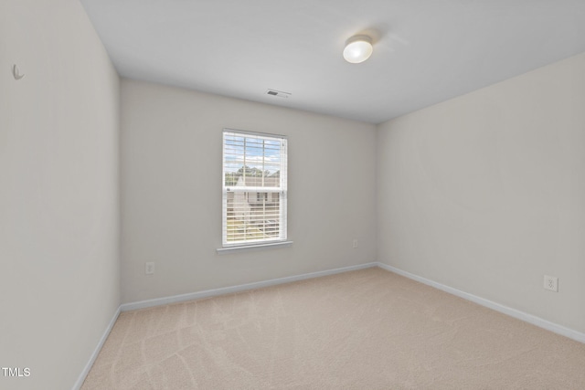 unfurnished room featuring baseboards, carpet, and visible vents