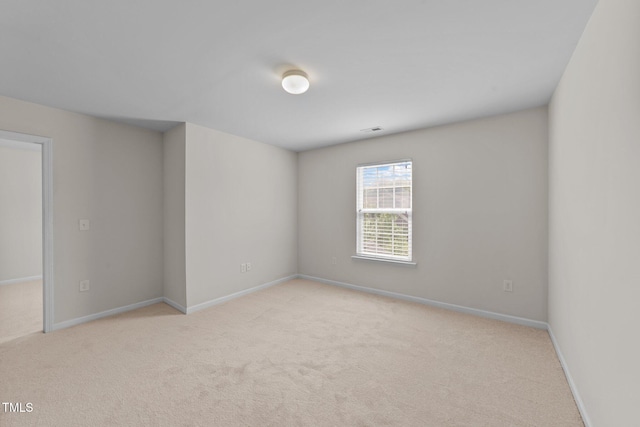 carpeted spare room with baseboards