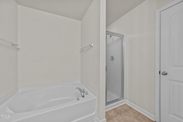 full bath with baseboards, tile patterned floors, a bath, and a shower stall