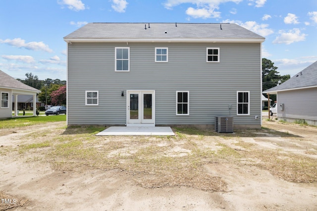 rear view of house with a patio area and central AC