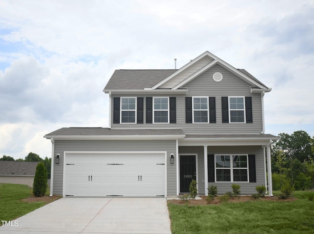 view of front of home featuring a front lawn and a garage