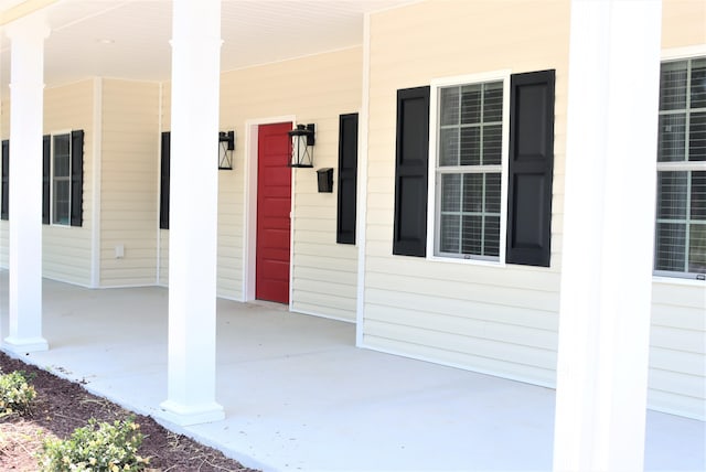 view of exterior entry featuring a porch