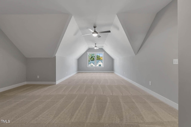 bonus room featuring ceiling fan, lofted ceiling, and light carpet