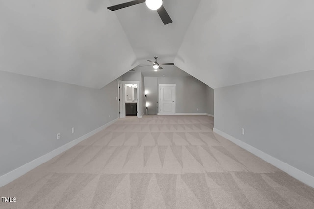 additional living space featuring light carpet, vaulted ceiling, and ceiling fan