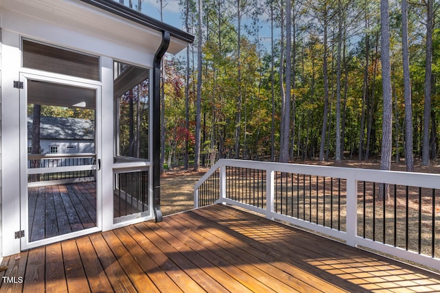 wooden deck featuring a sunroom