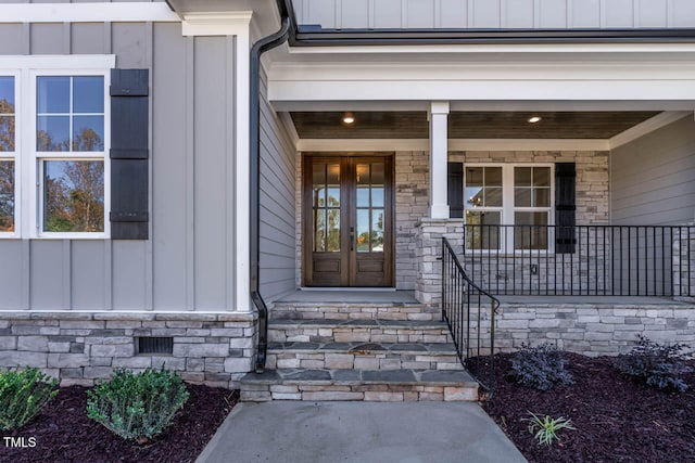 entrance to property featuring covered porch and french doors