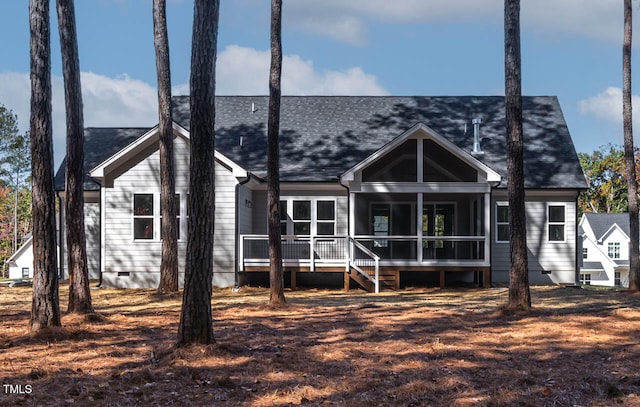 back of property with a sunroom