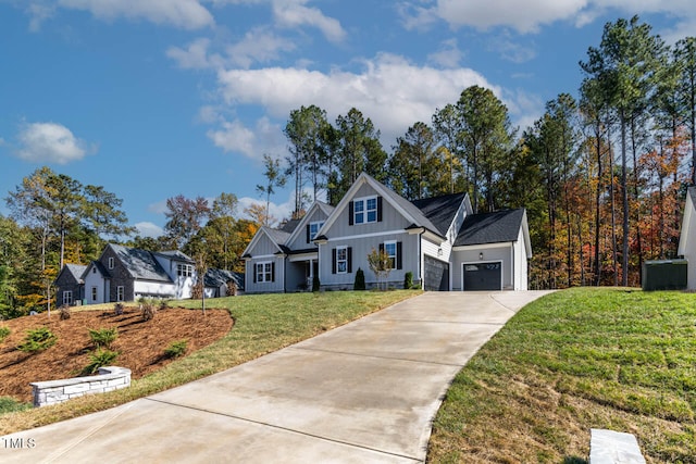 view of front of home with a garage and a front lawn