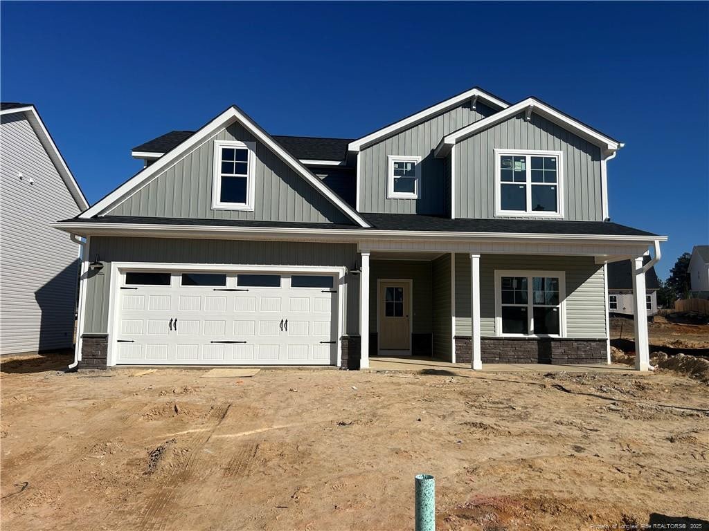 craftsman-style home with covered porch and a garage