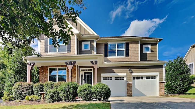 craftsman inspired home with a garage and concrete driveway