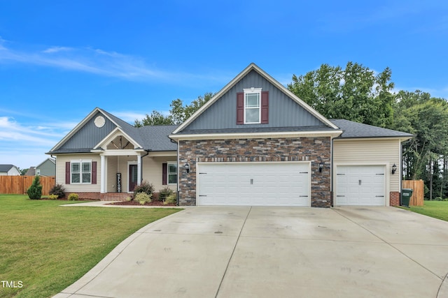 craftsman inspired home featuring a garage and a front lawn