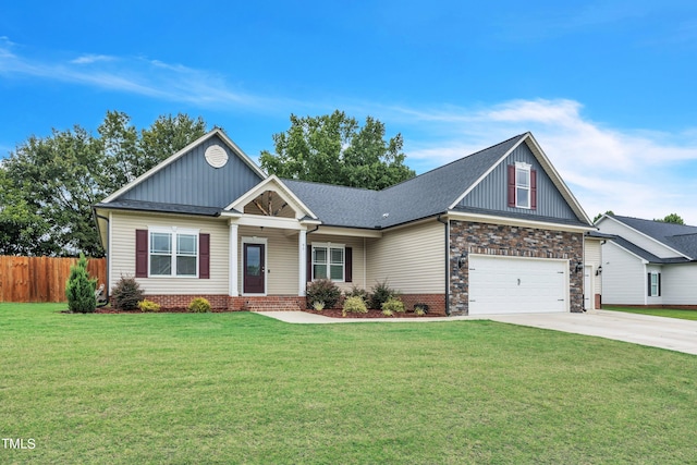 craftsman inspired home with a garage and a front lawn