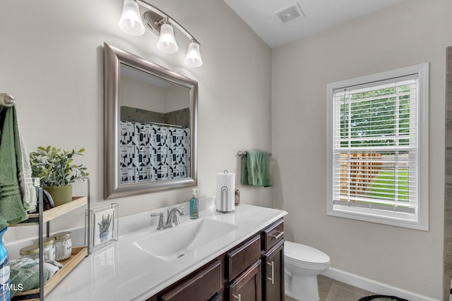 bathroom featuring tile patterned floors, vanity, and toilet