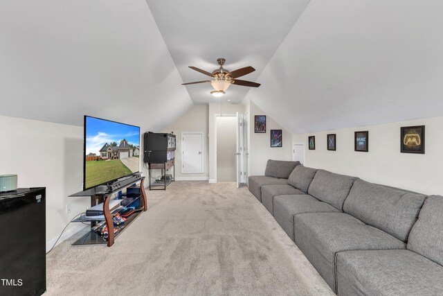 living room featuring ceiling fan, lofted ceiling, and light colored carpet