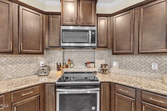 kitchen featuring appliances with stainless steel finishes, tasteful backsplash, and light stone countertops