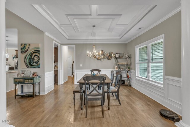 dining area with hardwood / wood-style floors, crown molding, a notable chandelier, and coffered ceiling