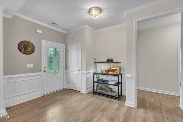 entrance foyer with light wood-type flooring and ornamental molding