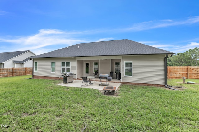 rear view of house with a patio area and a yard